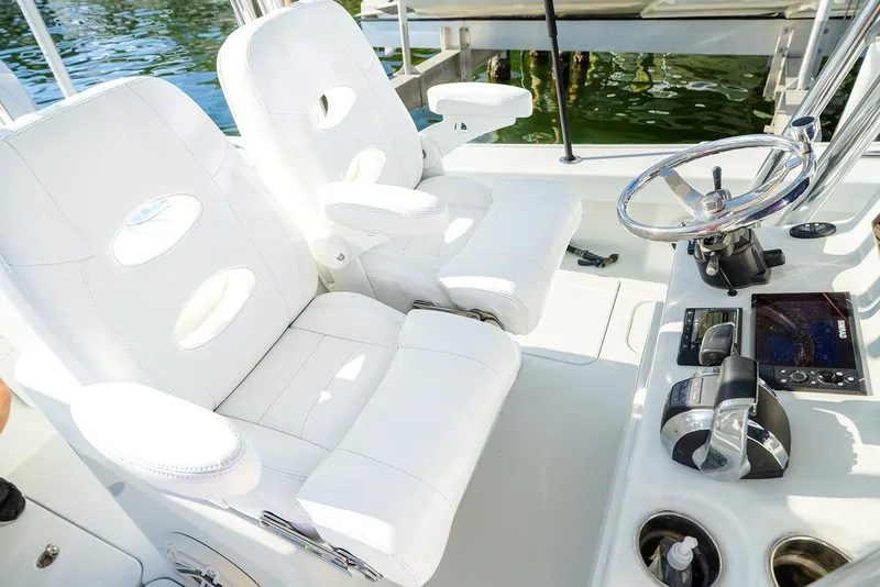 Slide: The Image of 2020 Costa Custom Boats 264HC helm with white seating and modern controls. - 23