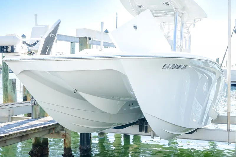 Slide: The Image of 2020 Costa Custom Boats 264HC on lift, showcasing sleek hull design. - 30