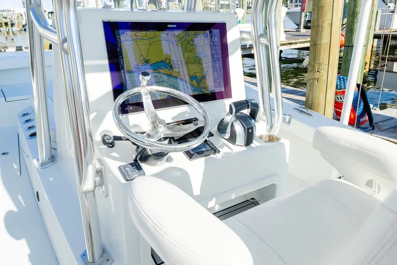 Slide: The Image of 2020 Costa Custom Boats 264HC helm with navigation display and steering wheel. - 27