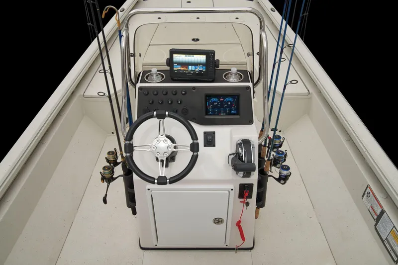 Slide: The Image of The image shows the cockpit of a 2024 Ranger RB210 boat with controls and fishing rods. - 47