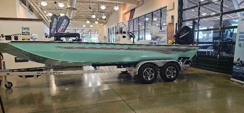 The Image of 2024 Ranger RB210 boat on display in showroom with trailer. - 0