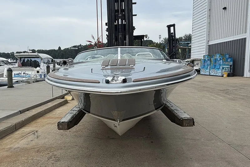 Slide: The Image of 2011 Chris-Craft Silver Bullet 20 boat docked at a marina, front view. - 2