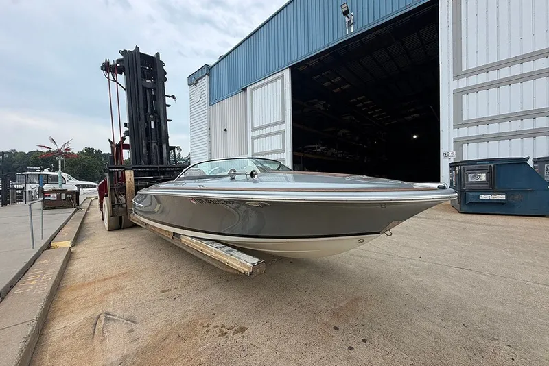 Slide: The Image of 2011 Chris-Craft Silver Bullet 20 boat on forklift near warehouse entrance. - 3