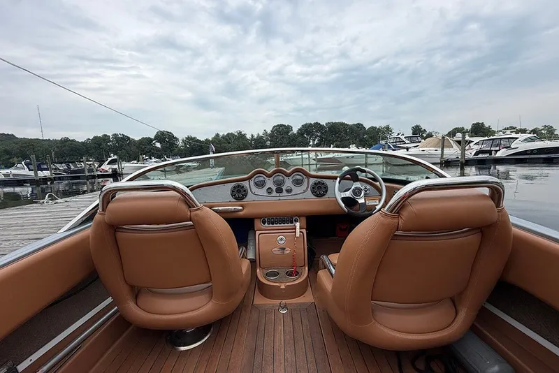 Slide: The Image of Interior view of 2011 Chris-Craft Silver Bullet 20 boat with leather seats and dashboard. - 13