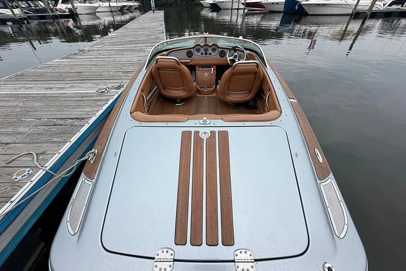 Slide: The Image of 2011 Chris-Craft Silver Bullet 20 boat docked, showcasing elegant interior and sleek design. - 9