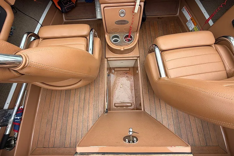 Slide: The Image of Interior of 2011 Chris-Craft Silver Bullet 20 boat with tan leather seats and wood flooring. - 20