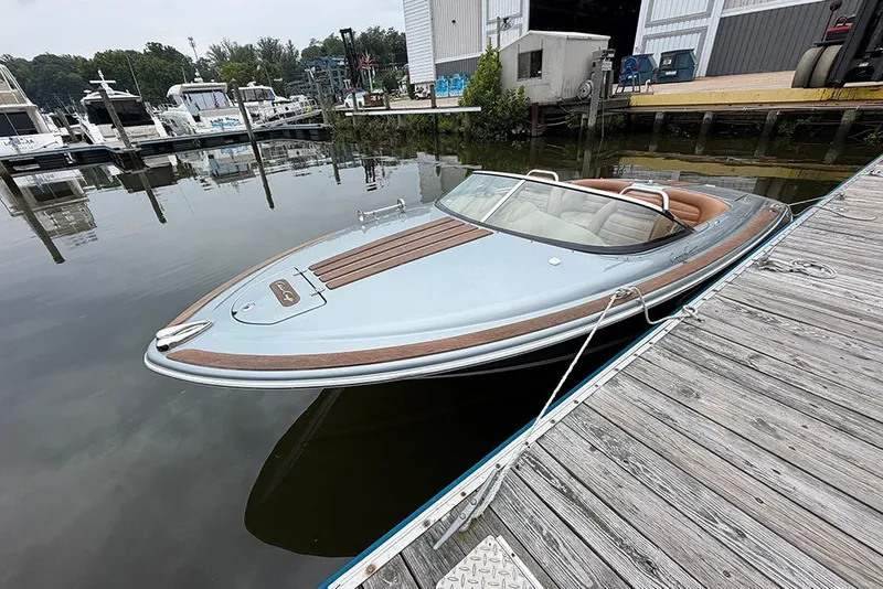 Slide: The Image of 2011 Chris-Craft Silver Bullet 20 boat docked at marina, showcasing sleek design and luxury features. - 7