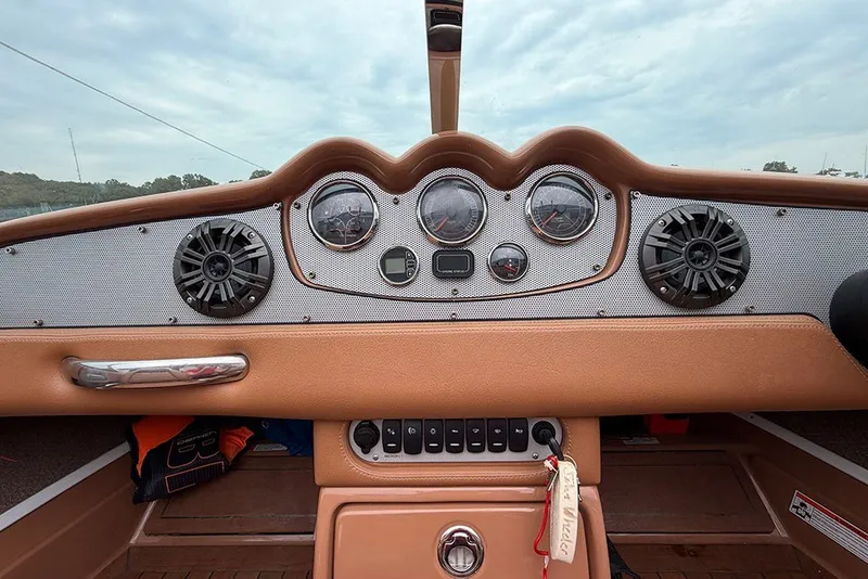 Slide: The Image of Dashboard of a 2011 Chris-Craft Silver Bullet 20 boat with gauges and speakers. - 17