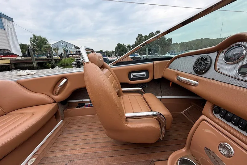 Slide: The Image of Interior of a 2011 Chris-Craft Silver Bullet 20 boat with tan leather seats and wooden flooring. - 19