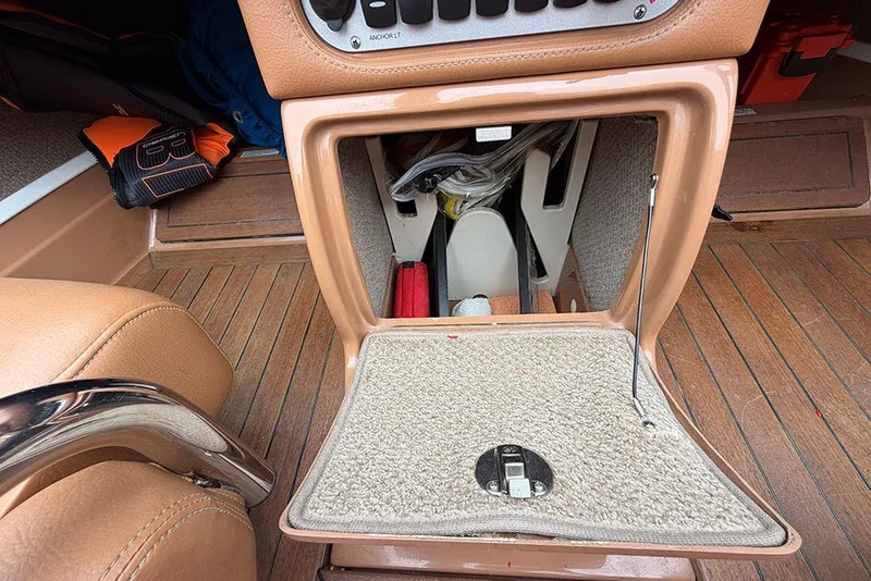 Slide: The Image of Open storage compartment in 2011 Chris-Craft Silver Bullet 20 boat, featuring wood and leather interior. - 18