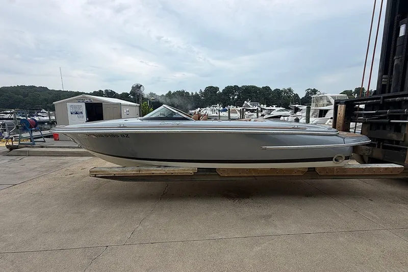 Slide: The Image of 2011 Chris-Craft Silver Bullet 20 boat on a dock, surrounded by marina scenery. - 4