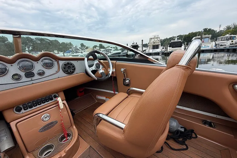 Slide: The Image of Interior of a 2011 Chris-Craft Silver Bullet 20 boat with tan leather seating. - 12