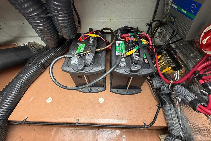 Slide: The Image of 2011 Chris-Craft Silver Bullet 20 boat battery compartment with wiring and components. - 23