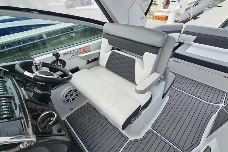 Slide: The Image of Cockpit of 2021 Monterey 295 Sport Yacht with sleek seating and modern controls. - 11
