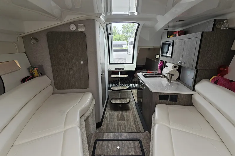 Slide: The Image of Interior of 2021 Monterey 295 Sport Yacht with modern kitchen and seating area. - 16