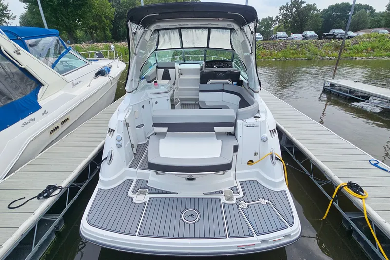 Slide: The Image of 2021 Monterey 295 Sport Yacht docked, featuring spacious seating and sleek design. - 4