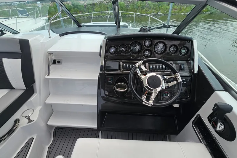 Slide: The Image of Cockpit of 2021 Monterey 295 Sport Yacht with modern steering and control panel. - 12