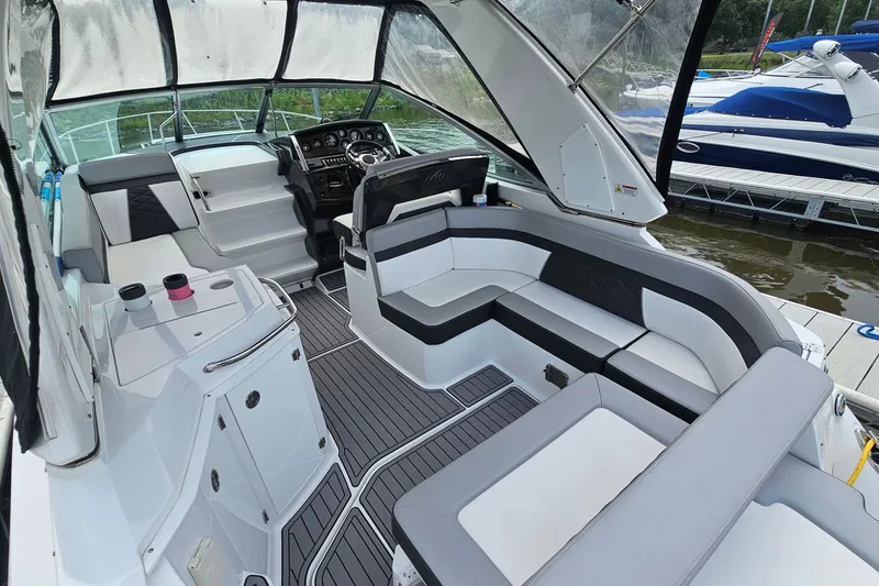 Slide: The Image of 2021 Monterey 295 Sport Yacht interior with sleek seating and modern dashboard design. - 5