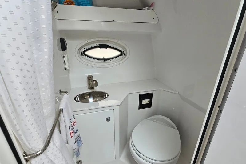 Slide: The Image of Bathroom interior of 2021 Monterey 295 Sport Yacht with sink and toilet. - 19