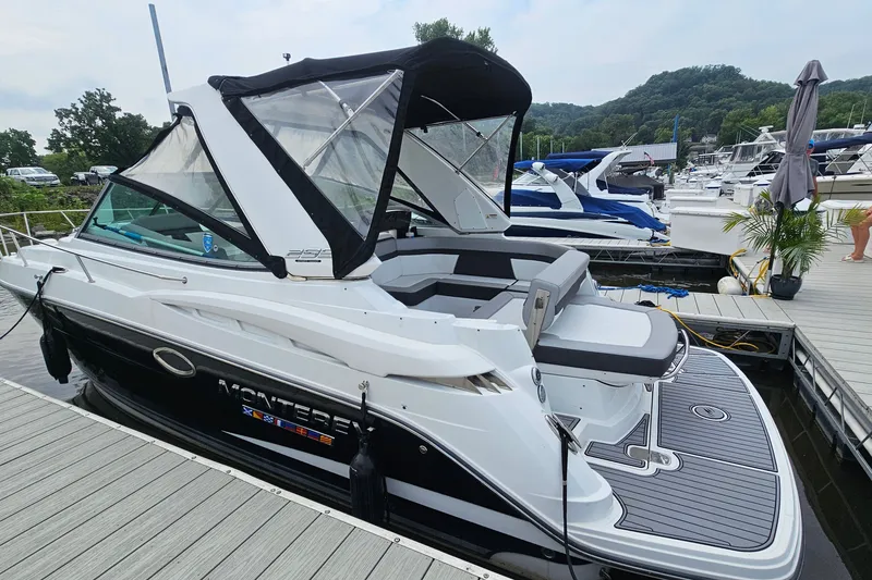 Slide: The Image of 2021 Monterey 295 Sport Yacht docked at marina, featuring sleek design and spacious deck. - 3