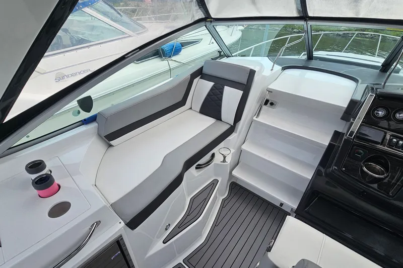 Slide: The Image of 2021 Monterey 295 Sport Yacht interior with sleek seating and modern dashboard design. - 9