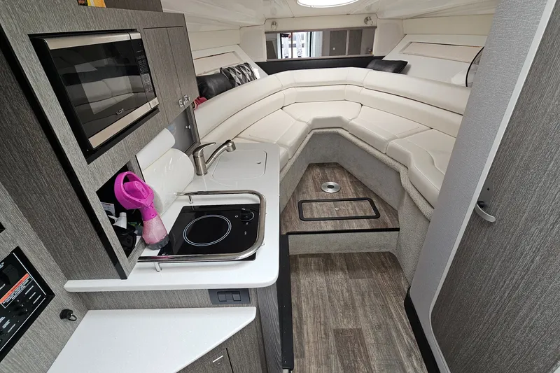 Slide: The Image of 2021 Monterey 295 Sport Yacht interior with kitchenette and seating area. - 13