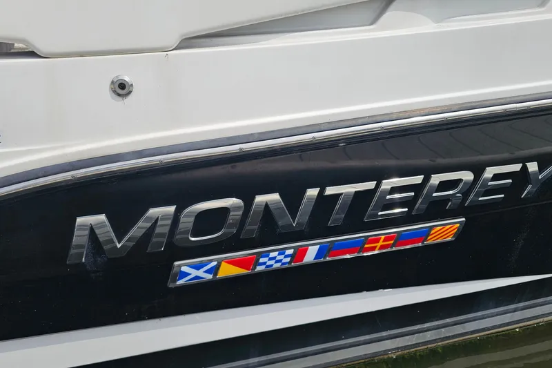 Slide: The Image of Monterey 295 Sport Yacht 2021 emblem with nautical flags on hull. - 24