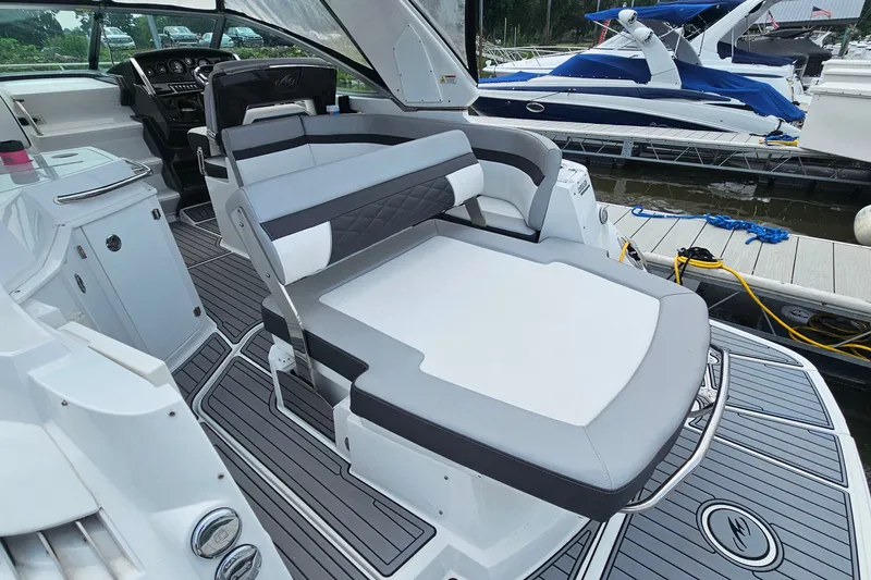 Slide: The Image of 2021 Monterey 295 Sport Yacht interior with sleek seating and modern dashboard at marina. - 7