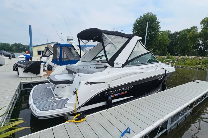 The Image of 2021 Monterey 295 Sport Yacht docked at marina, featuring sleek design and modern amenities. - 1