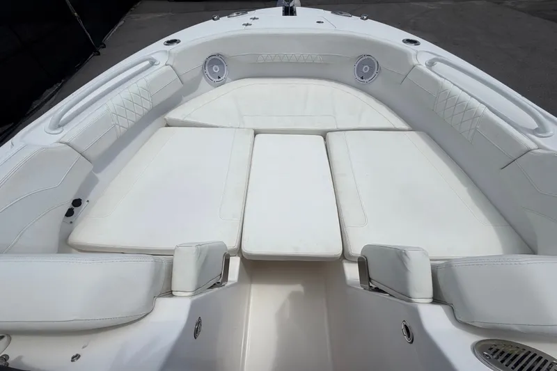 Slide: The Image of 2023 Edgewater 248CX Crossover boat interior with white cushioned seating. - 59
