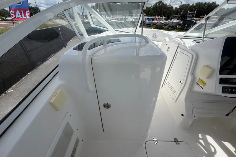 Slide: The Image of 2023 Edgewater 248CX Crossover boat interior with sleek white console and modern design. - 29