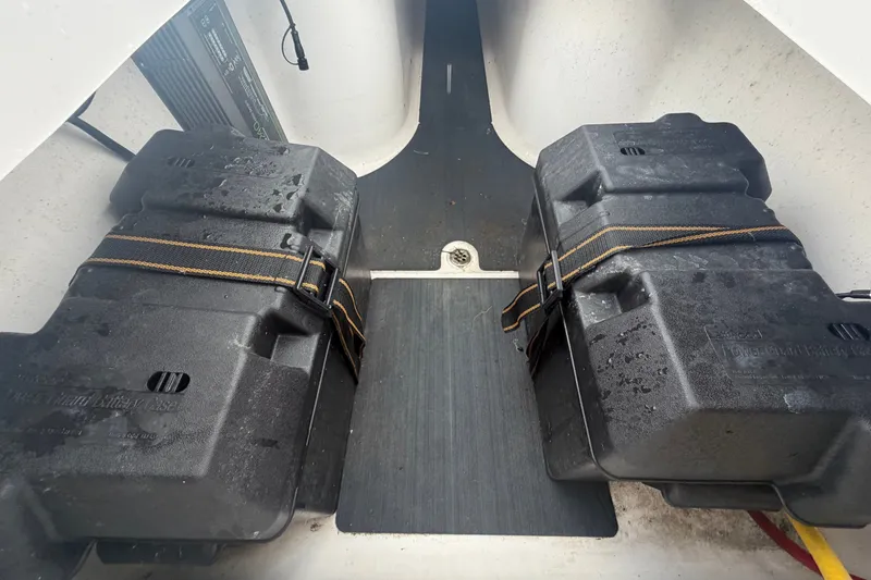 Slide: The Image of Battery compartment of the 2023 Edgewater 248CX Crossover with two secured batteries. - 25