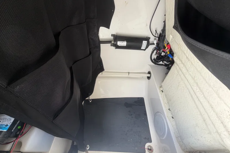Slide: The Image of Interior view of 2023 Edgewater 248CX Crossover boat showing storage and wiring. - 58