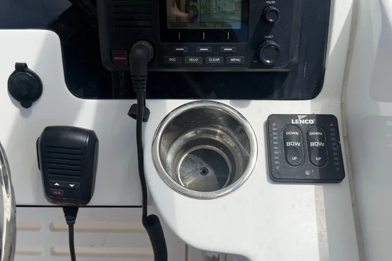 Slide: The Image of Control panel of 2023 Edgewater 248CX Crossover boat with radio and Lenco trim tab switches. - 45