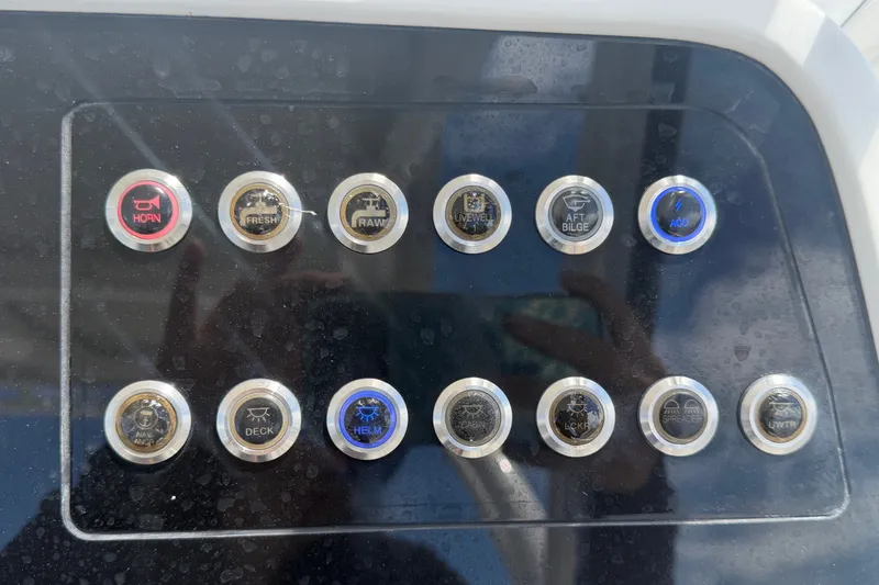 Slide: The Image of Control panel of 2023 Edgewater 248CX Crossover boat with labeled buttons. - 41