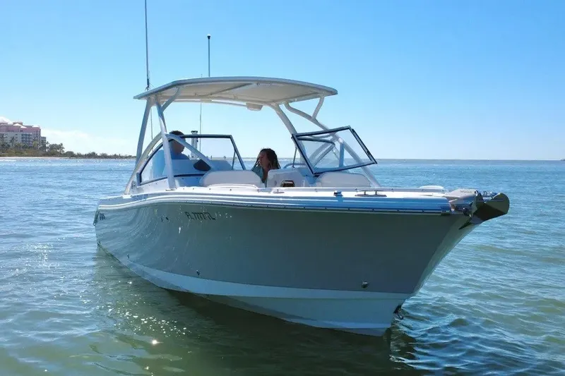 Slide: The Image of 2023 Edgewater 248CX Crossover boat cruising on calm ocean waters. - 16