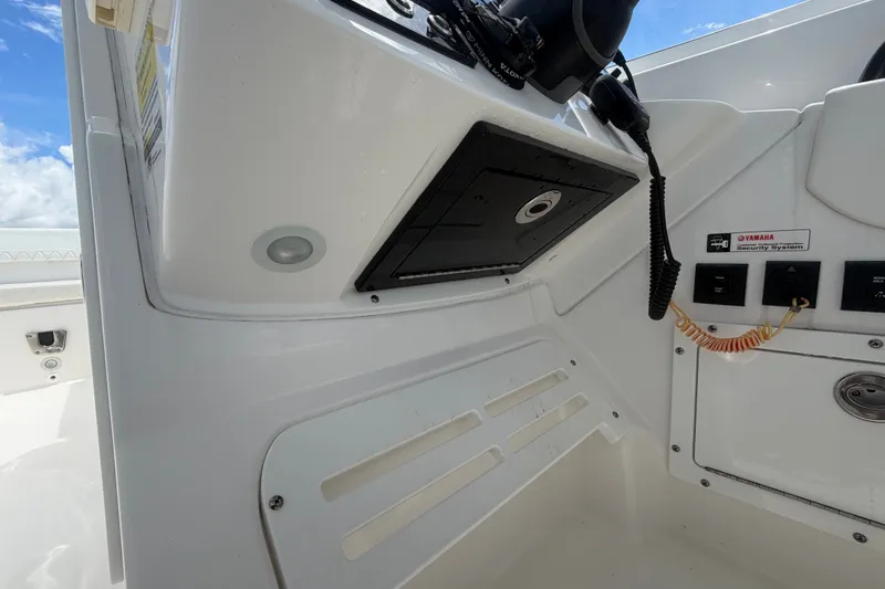 Slide: The Image of 2023 Edgewater 248CX Crossover boat dashboard with Yamaha security system and controls. - 52