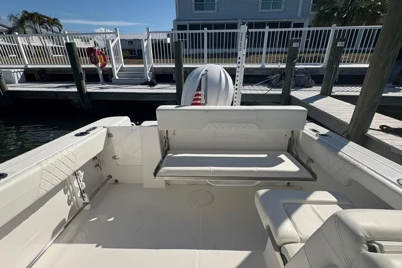 Slide: The Image of 2023 Edgewater 248CX Crossover boat interior with seating and dock view. - 26