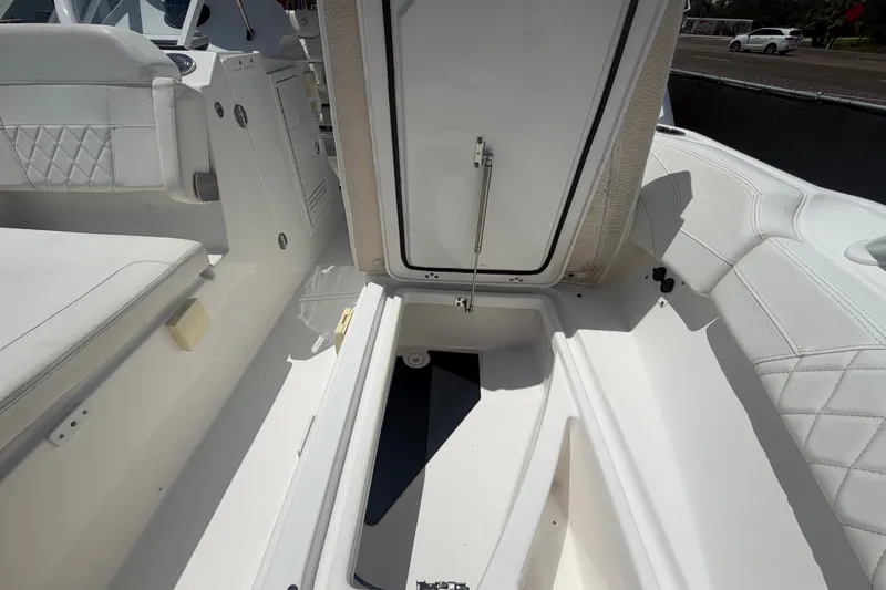 Slide: The Image of 2023 Edgewater 248CX Crossover boat interior with open storage compartment. - 72