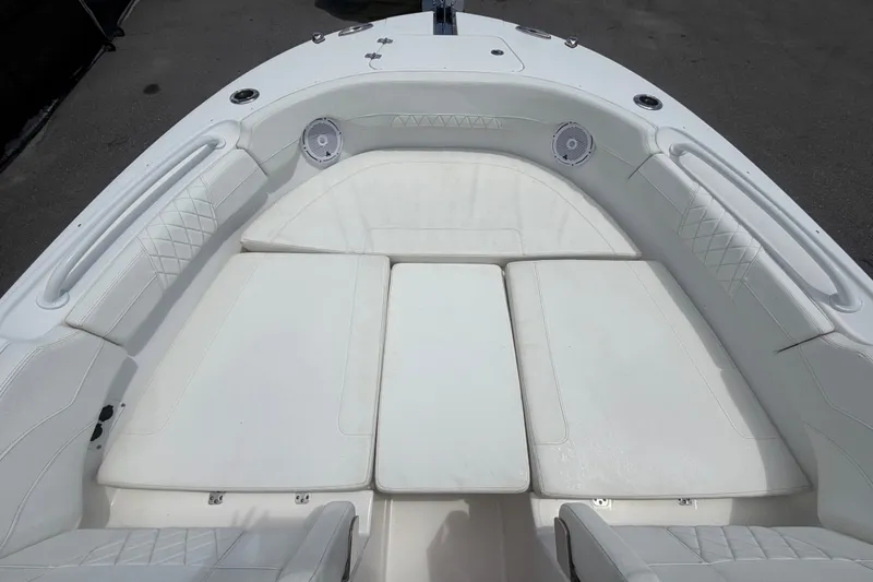 Slide: The Image of 2023 Edgewater 248CX Crossover boat interior with white cushioned seating. - 60