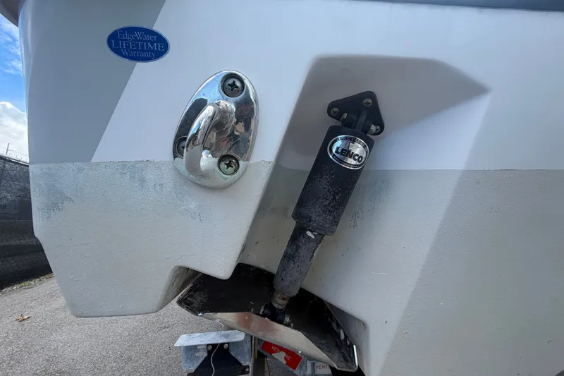 Slide: The Image of 2023 Edgewater 248CX Crossover boat with Lenco trim tab and lifetime warranty badge. - 6