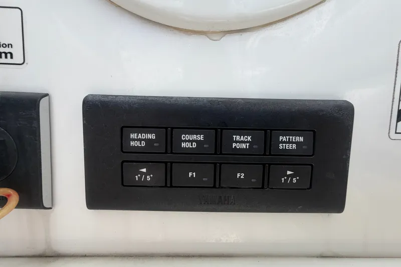 Slide: The Image of Control panel on 2023 Edgewater 248CX Crossover boat with navigation buttons. - 50