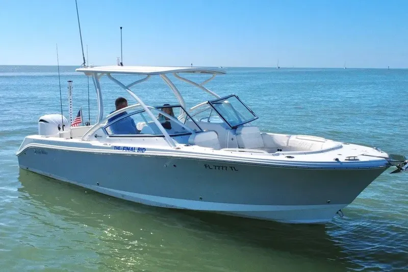 Slide: The Image of 2023 Edgewater 248CX Crossover boat cruising on calm blue waters. - 18