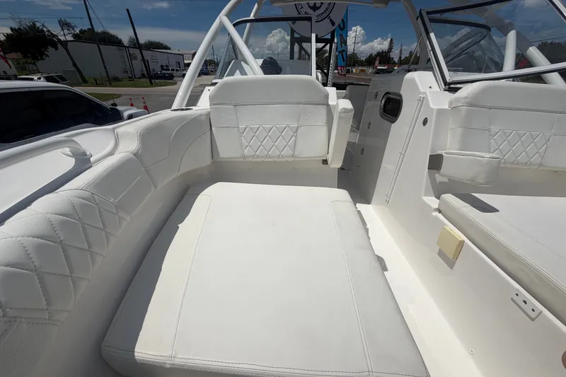 Slide: The Image of 2023 Edgewater 248CX Crossover boat interior with white cushioned seating. - 69
