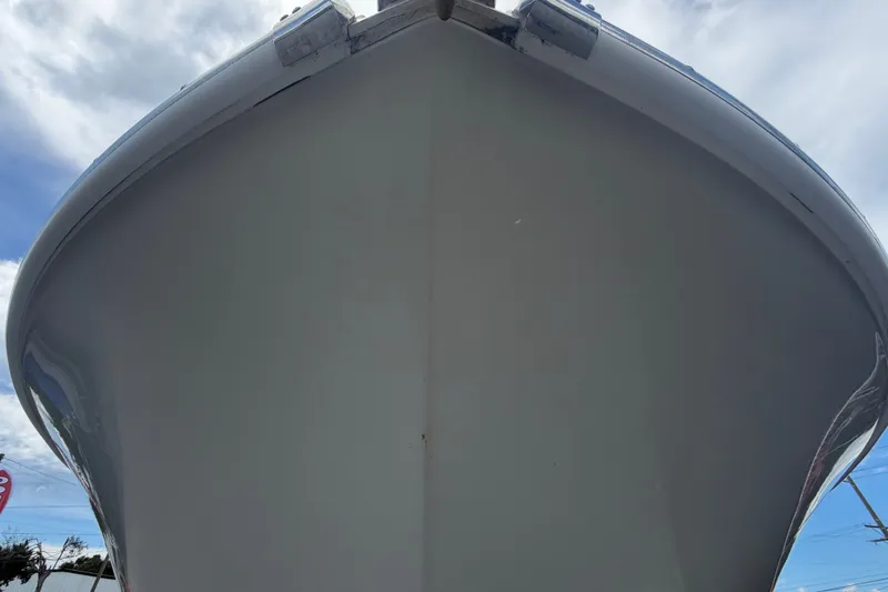 Slide: The Image of Bow view of a 2023 Edgewater 248CX Crossover under a cloudy sky. - 10