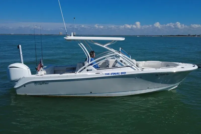 The Image of 2023 Edgewater 248CX Crossover boat on calm blue water, side view. - 1