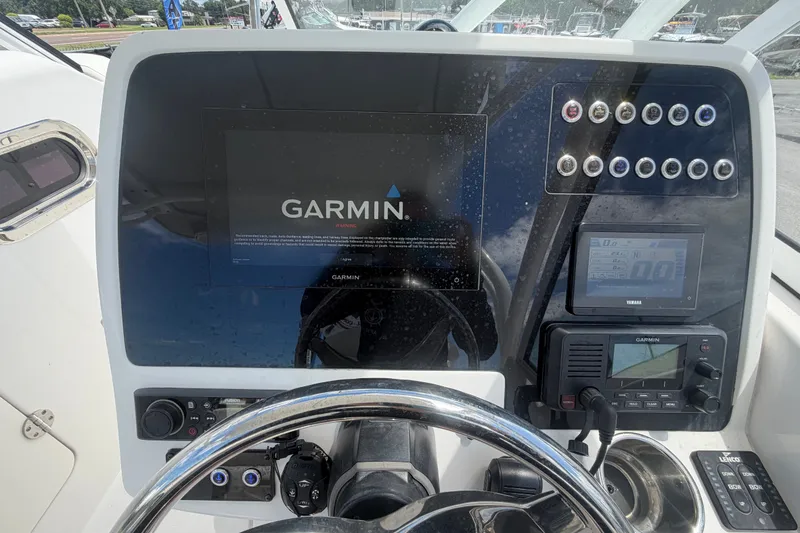 Slide: The Image of 2023 Edgewater 248CX Crossover boat dashboard with Garmin navigation system and controls. - 39