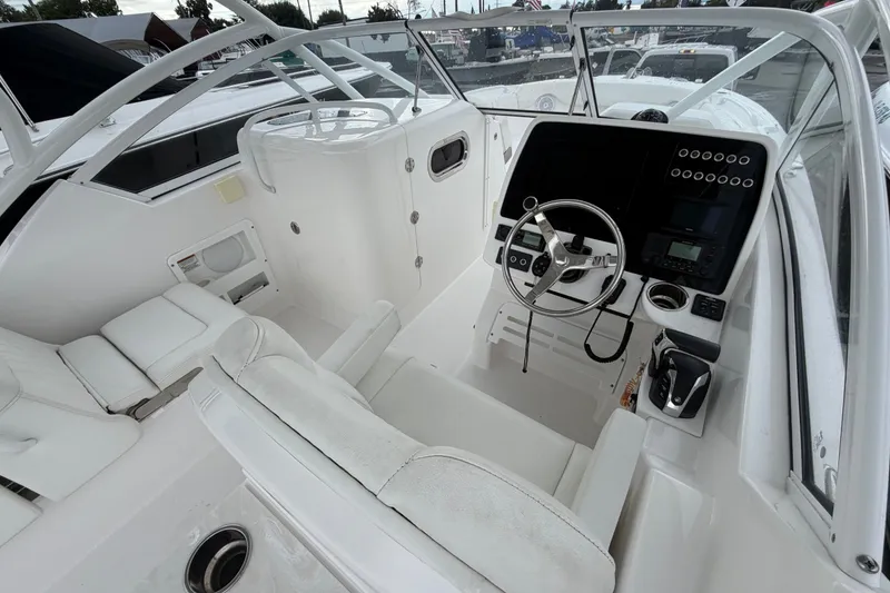 Slide: The Image of 2023 Edgewater 248CX Crossover boat interior with steering wheel and control panel. - 4