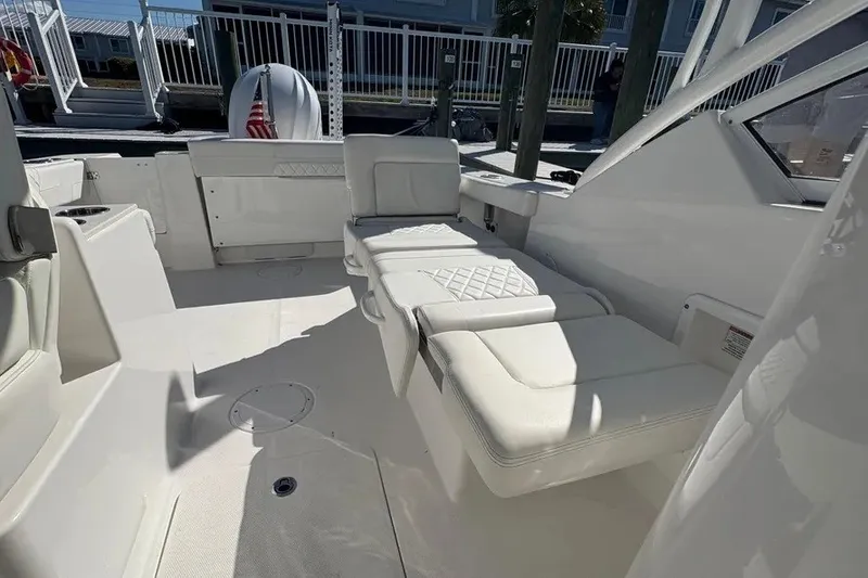 Slide: The Image of 2023 Edgewater 248CX Crossover boat interior with white seating and modern design. - 30