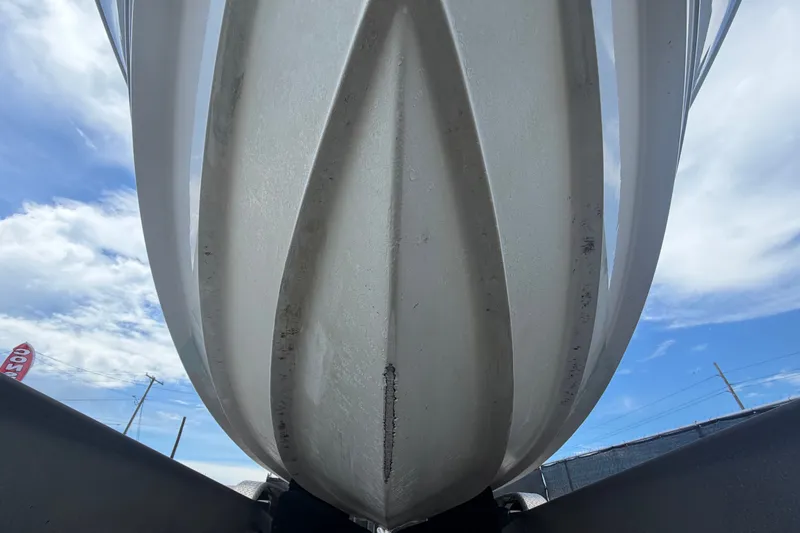 Slide: The Image of Close-up of 2023 Edgewater 248CX Crossover boat hull against a blue sky. - 12